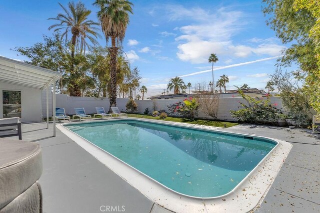 view of pool featuring a patio area, a fenced backyard, and a fenced in pool