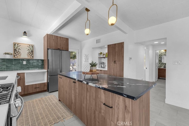 kitchen with beam ceiling, visible vents, stainless steel appliances, and modern cabinets