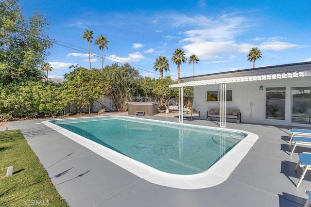 pool featuring a patio, fence, and a hot tub