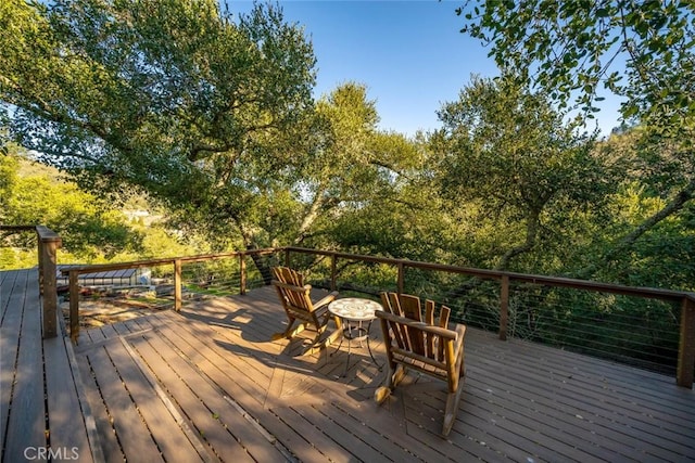 wooden deck with a fire pit