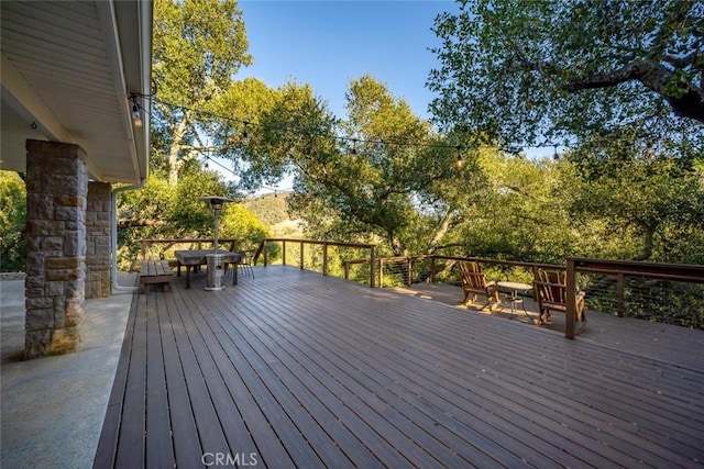 wooden terrace featuring outdoor dining space