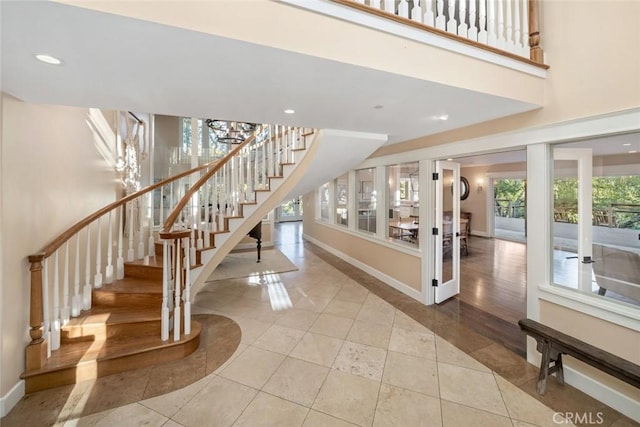 stairs with recessed lighting, tile patterned flooring, and baseboards