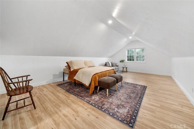 bedroom with lofted ceiling, baseboards, wood finished floors, and recessed lighting