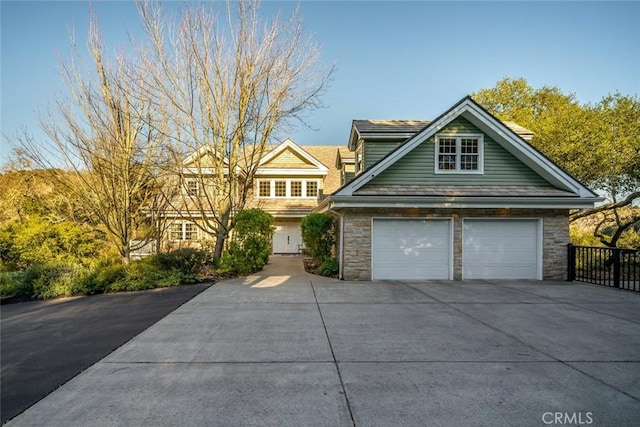 view of front of property with stone siding and driveway