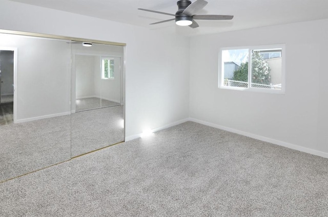 unfurnished bedroom featuring ceiling fan and a closet