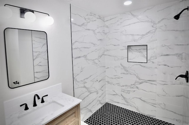 bathroom featuring vanity and a tile shower