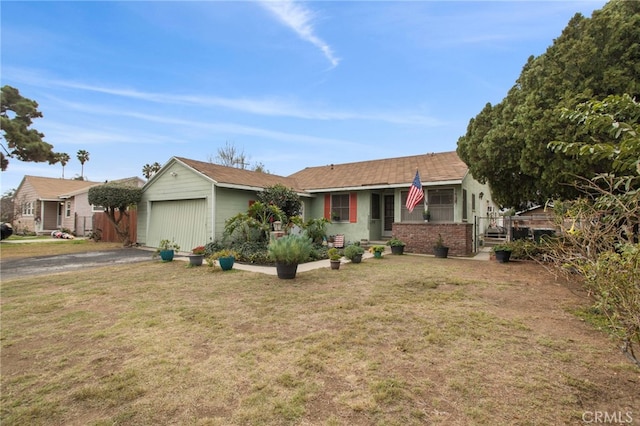 single story home with a garage and a front lawn