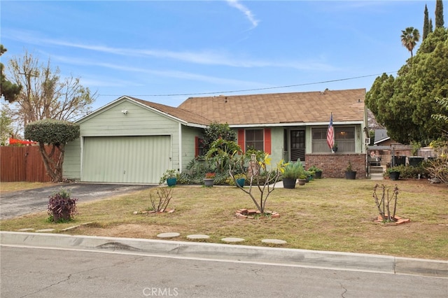 ranch-style house with a garage and a front lawn