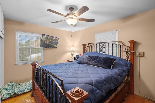 bedroom featuring hardwood / wood-style flooring and ceiling fan