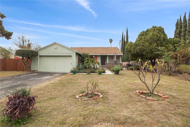 ranch-style home featuring a garage and a front lawn