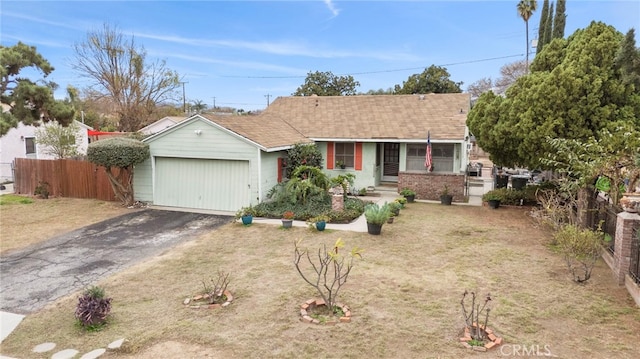 single story home featuring a garage and a front yard