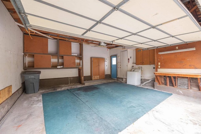 garage with washer / dryer and a workshop area