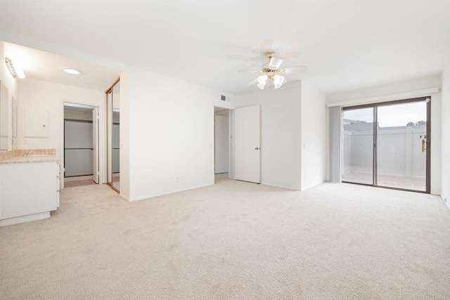 unfurnished room with ceiling fan and light colored carpet