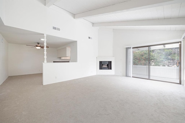 unfurnished living room featuring beam ceiling, high vaulted ceiling, carpet flooring, ceiling fan, and a fireplace