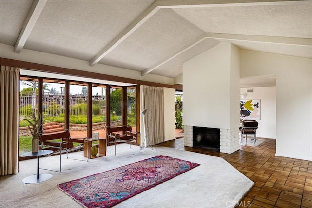 living room featuring a fireplace, high vaulted ceiling, beamed ceiling, and a textured ceiling