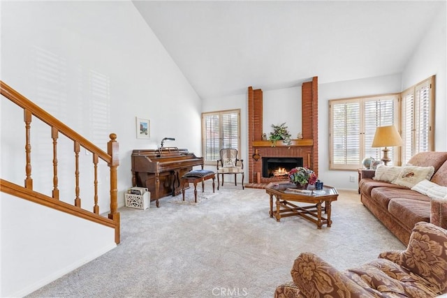 carpeted living room featuring a fireplace, high vaulted ceiling, and a wealth of natural light