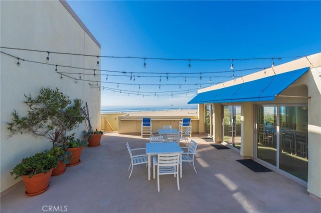 711 Pacific Coast Unit 313, Huntington Beach, CA 92648 - view of patio / terrace featuring outdoor dining area and a water view