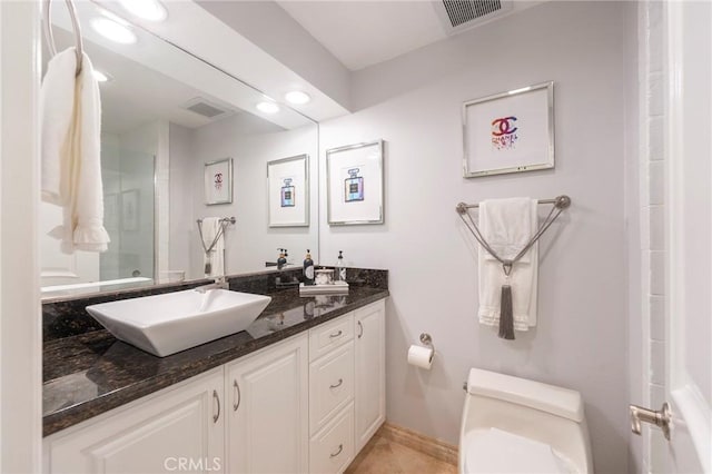 711 Pacific Coast Unit 313, Huntington Beach, CA 92648 - full bathroom with a sink, double vanity, toilet, visible vents, and walk in shower