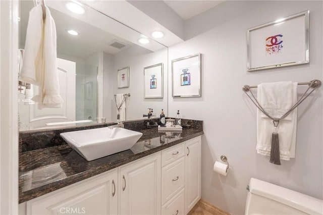 711 Pacific Coast Unit 313, Huntington Beach, CA 92648 - bathroom with toilet, visible vents, baseboards, a shower with door, and vanity