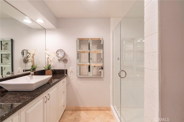 711 Pacific Coast Unit 313, Huntington Beach, CA 92648 - bathroom with a shower stall, baseboards, vanity, and tile patterned flooring