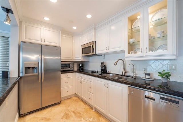 711 Pacific Coast Unit 313, Huntington Beach, CA 92648 - kitchen featuring a sink, dark stone counters, tasteful backsplash, white cabinetry, and appliances with stainless steel finishes