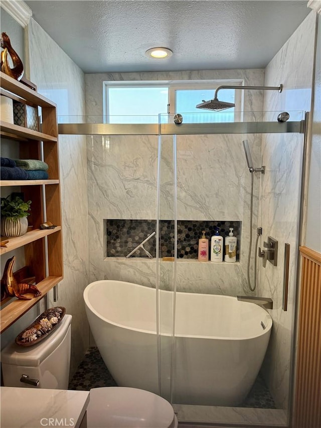 bathroom with a shower with door, toilet, a wealth of natural light, and a freestanding bath