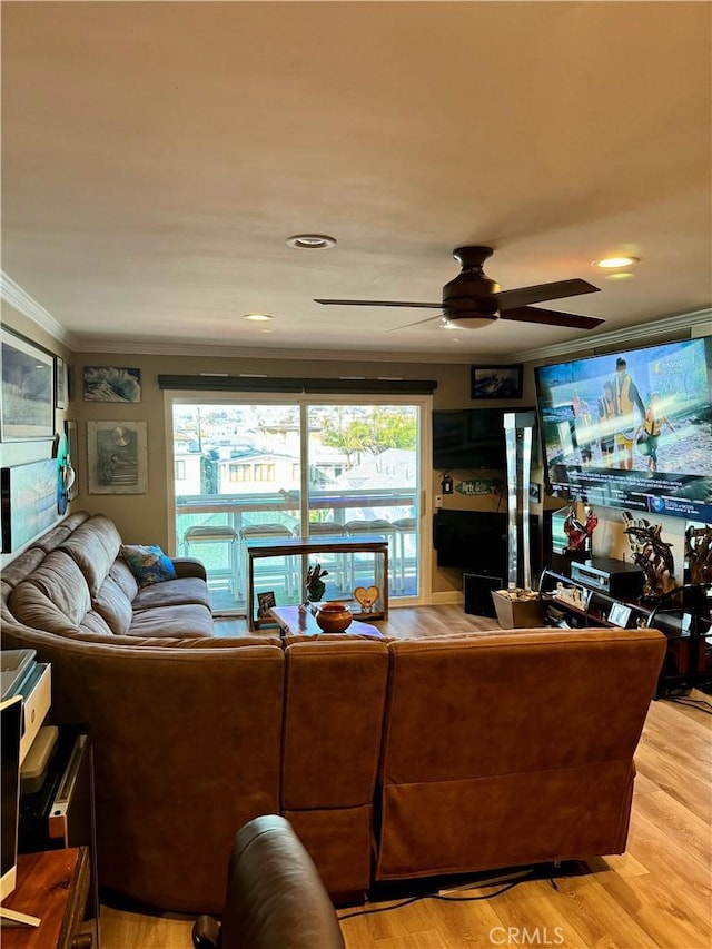 living area with ceiling fan, ornamental molding, and light wood finished floors