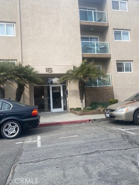 view of building exterior with uncovered parking