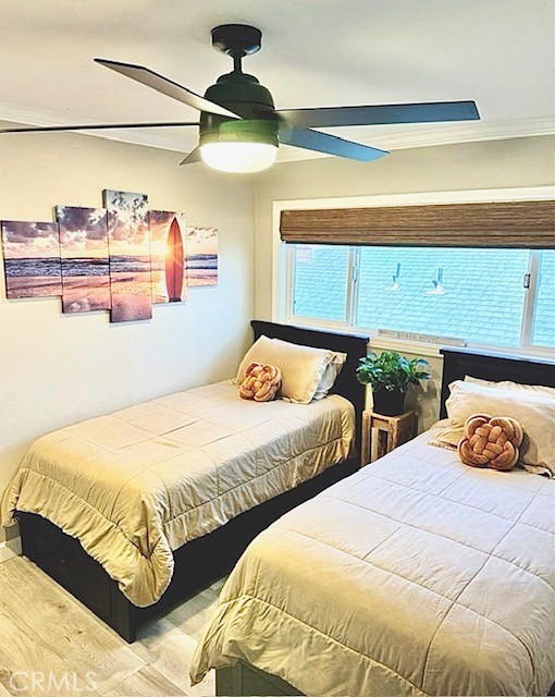 bedroom featuring ceiling fan and multiple windows