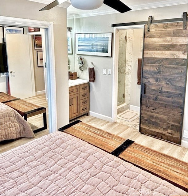 interior space featuring ceiling fan, crown molding, a shower stall, wood finished floors, and vanity