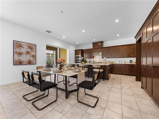 dining room with light tile patterned flooring and sink