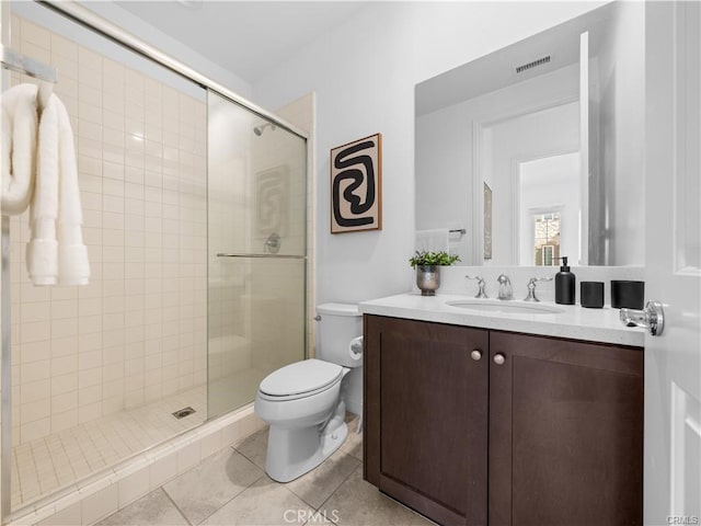 bathroom featuring walk in shower, tile patterned floors, toilet, and vanity