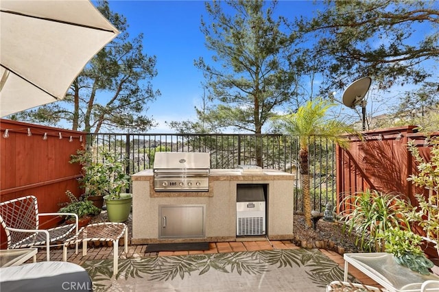 view of patio featuring an outdoor kitchen and area for grilling