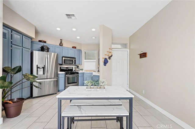 kitchen featuring stainless steel appliances and blue cabinets