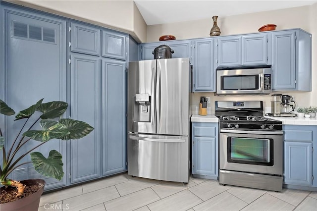 kitchen featuring blue cabinetry and appliances with stainless steel finishes