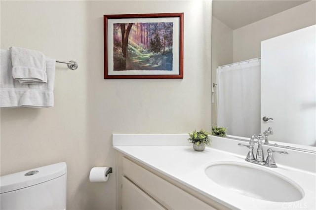 bathroom featuring vanity and toilet