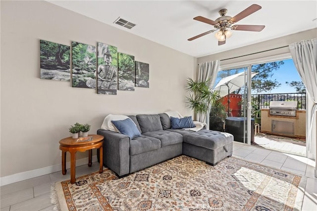 living room featuring ceiling fan and tile patterned floors