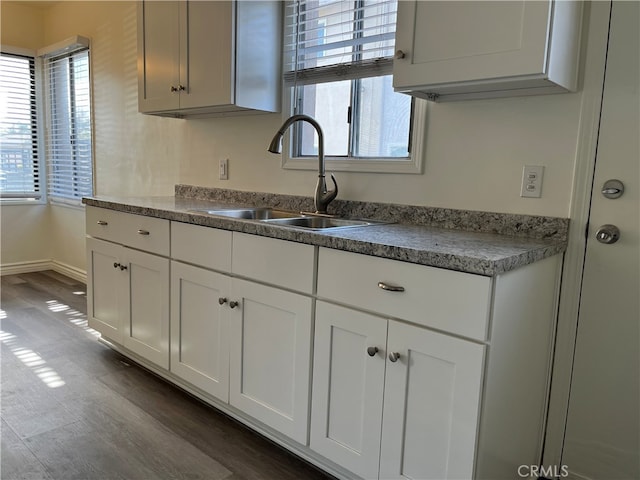 kitchen with white cabinetry, dark hardwood / wood-style floors, and sink