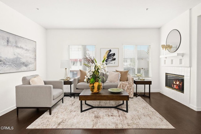 sitting room featuring dark hardwood / wood-style floors and a tile fireplace