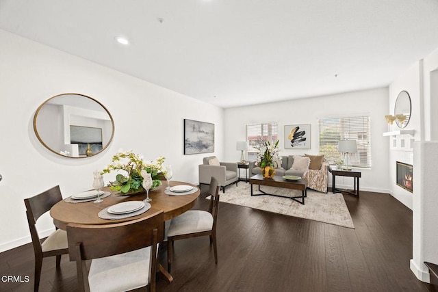 dining space with dark hardwood / wood-style flooring