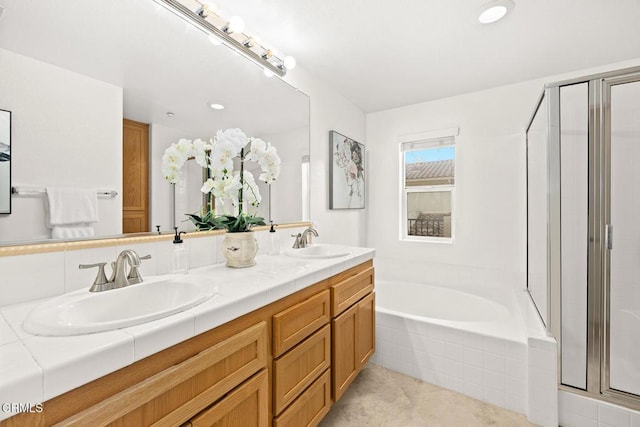 bathroom featuring vanity and separate shower and tub