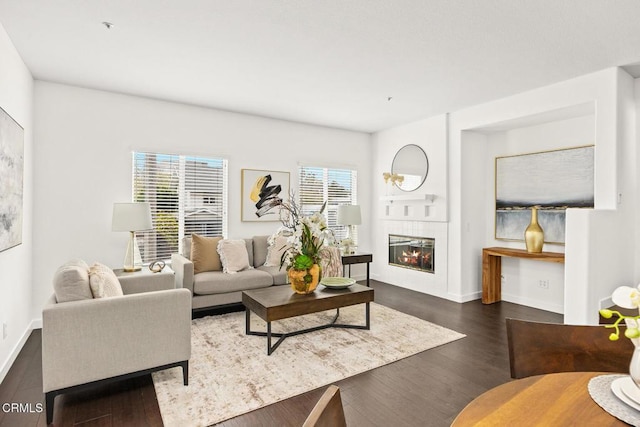 living room featuring dark hardwood / wood-style flooring and a tile fireplace