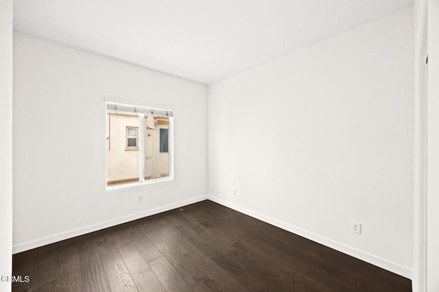 spare room with dark hardwood / wood-style floors