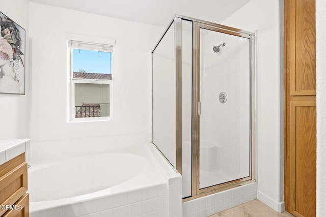 bathroom with vanity and shower with separate bathtub