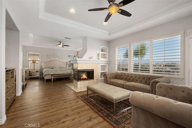 28622 Point Loma, Laguna Niguel, CA 92677 - living area featuring a tray ceiling, a ceiling fan, ornamental molding, plenty of natural light, and wood finished floors