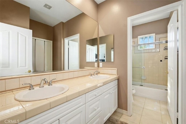 28622 Point Loma, Laguna Niguel, CA 92677 - full bathroom with toilet, double vanity, shower / bathtub combination, tile patterned flooring, and baseboards