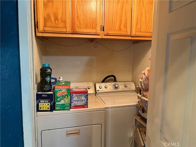 laundry room with cabinets and washer and dryer