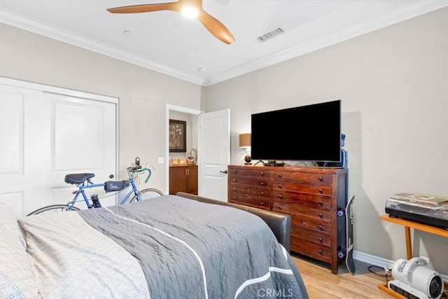 bedroom featuring a closet, visible vents, ornamental molding, light wood-type flooring, and baseboards