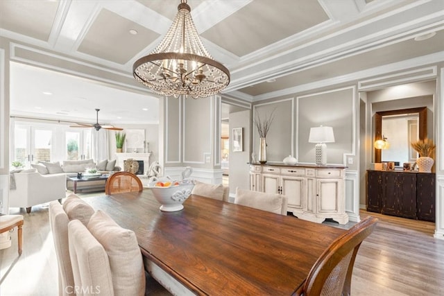 dining room featuring ornamental molding and a decorative wall