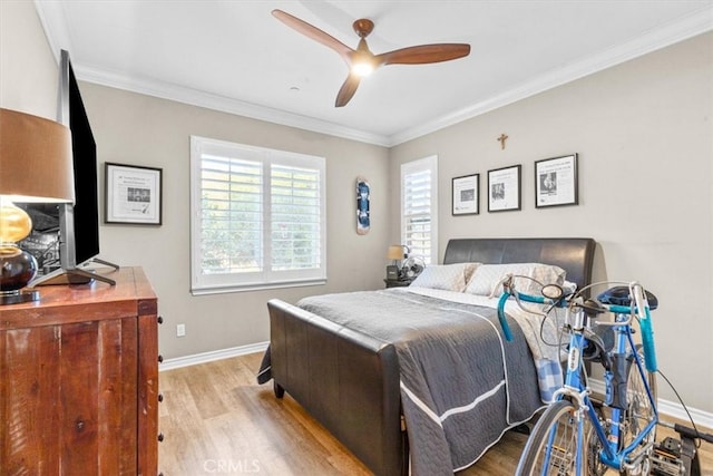 bedroom featuring a ceiling fan, baseboards, crown molding, and light wood finished floors